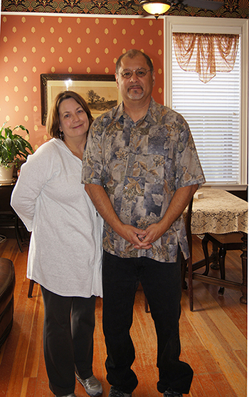 click to view larger image Larry and Marie Estrada in their restored Victorian home